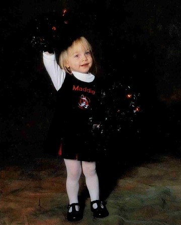 young Maddie in cheer uniform