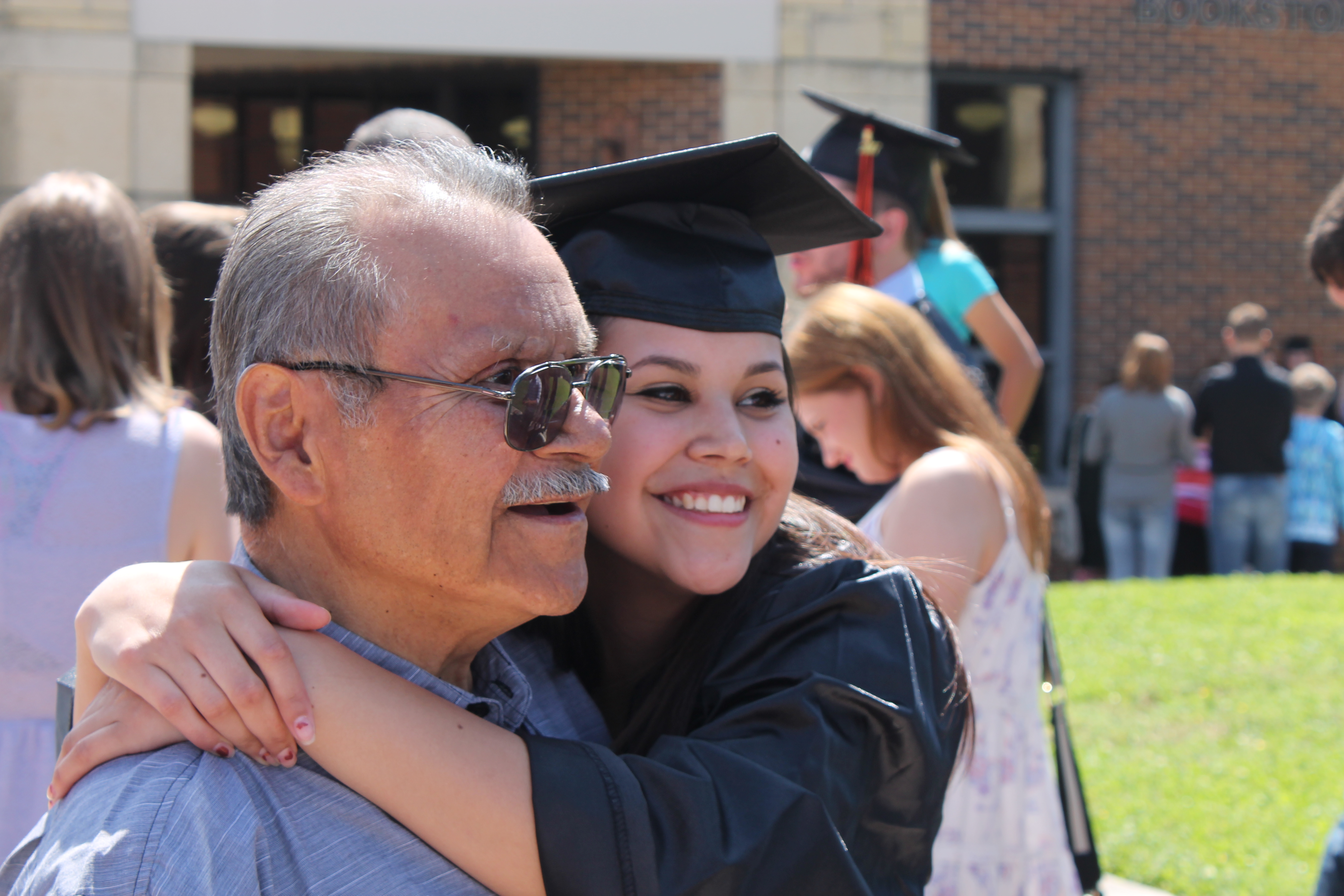 Two people hugging at a graduation