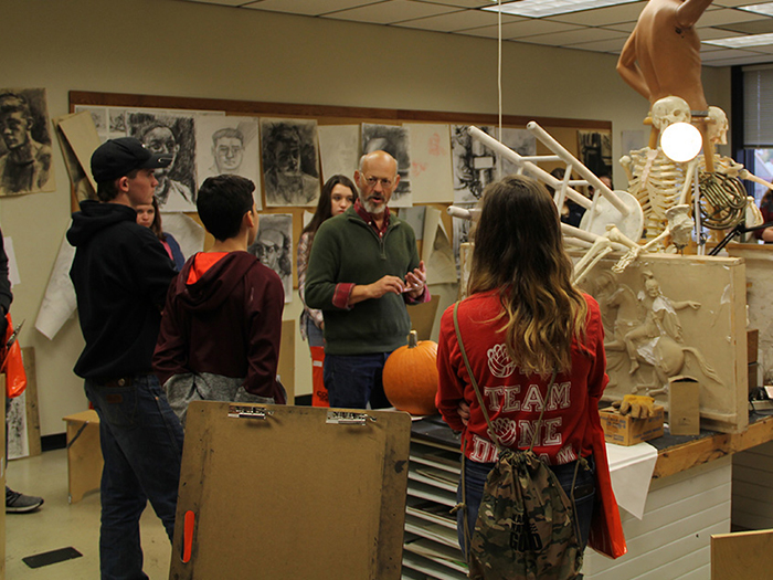 instructor with students in art classroom