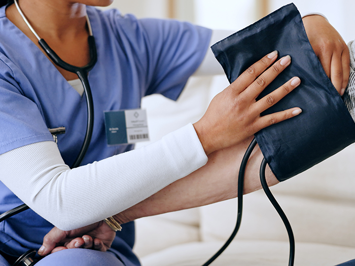 nurse using a blood pressure monitor